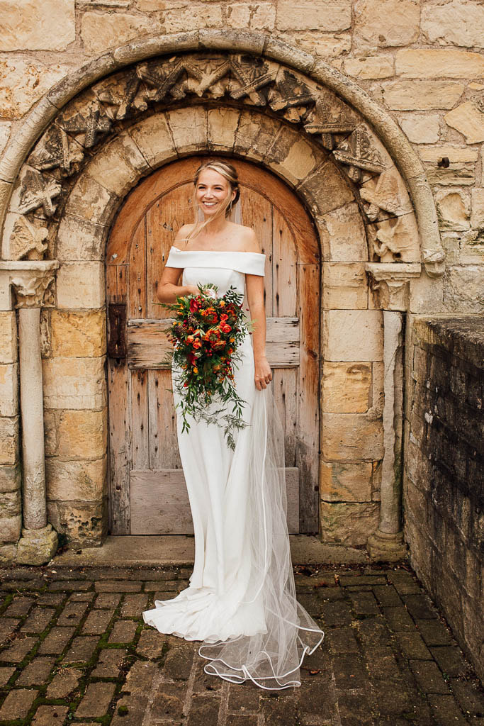 Beautiful bride with orange bouquet and long veil
