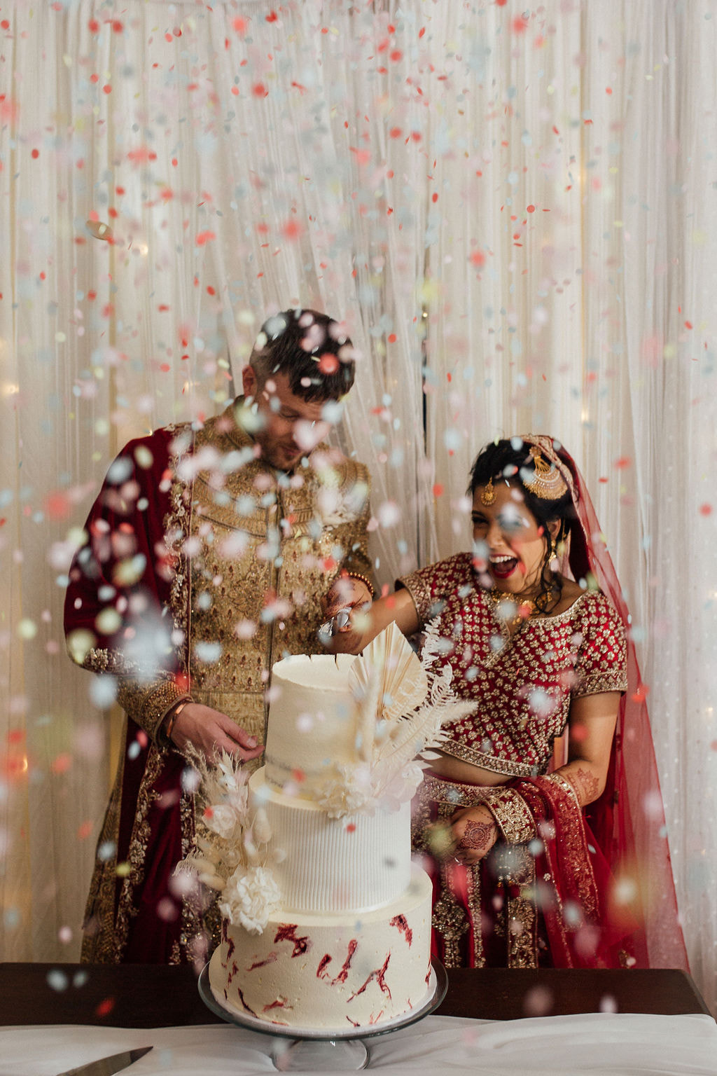 Confetti canons and wedding cake at Indian fusion wedding